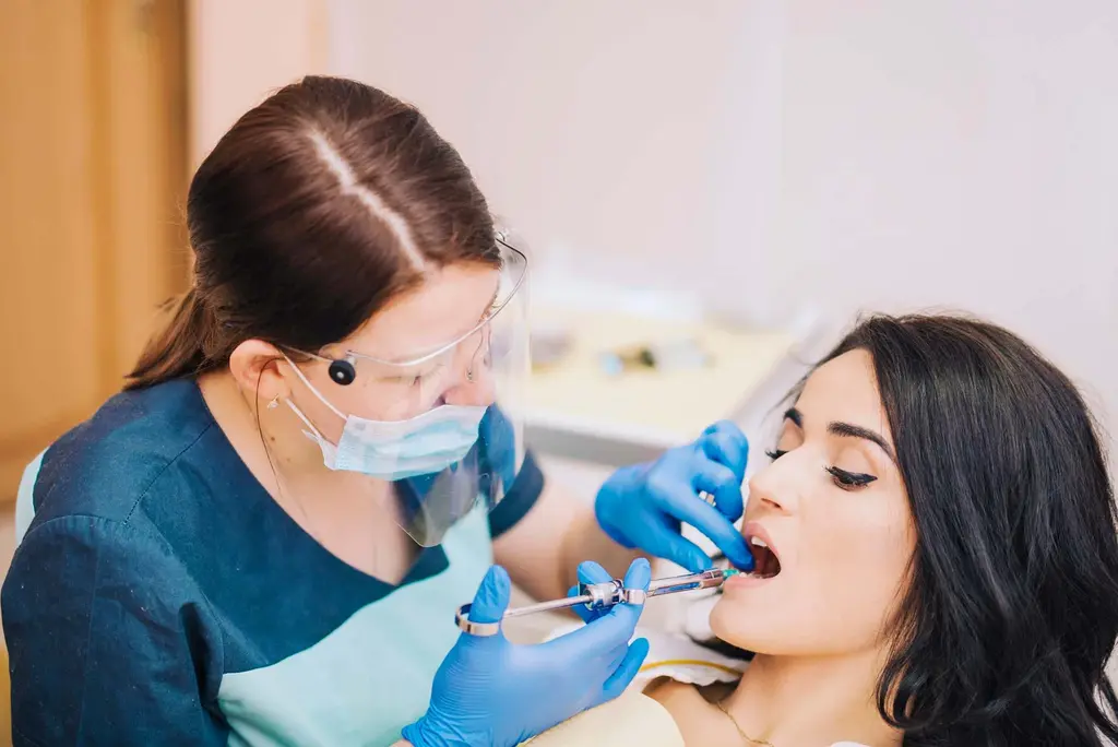 orthodontist-checking-teeth-of-a-woman